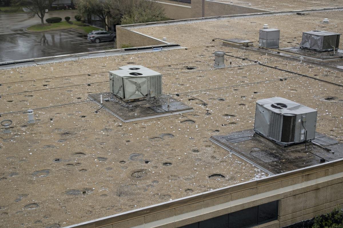 commercial storm damage on a flat roof in Lewisville, TX after a DFW hailstorm